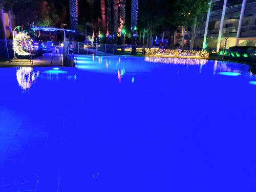 a swimming pool at night with blue lights at Barak Royal suites VIP 46 - חמש דקות מהים ומהטיילת in Eilat