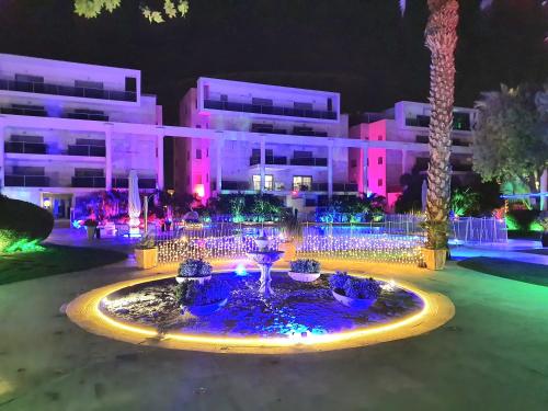 a fountain in front of a building at night at Barak Royal suites VIP 46 - חמש דקות מהים ומהטיילת in Eilat