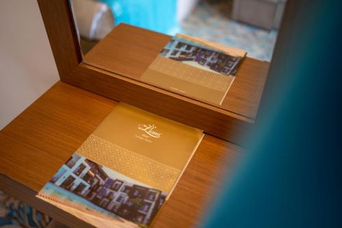 two boxes sitting on top of a wooden table at Liona Hotel & SPA in Gundogan