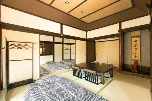 a room with two beds and a table in it at Traditional/modern Kyoto Paradise in quiet area! in Iwakura
