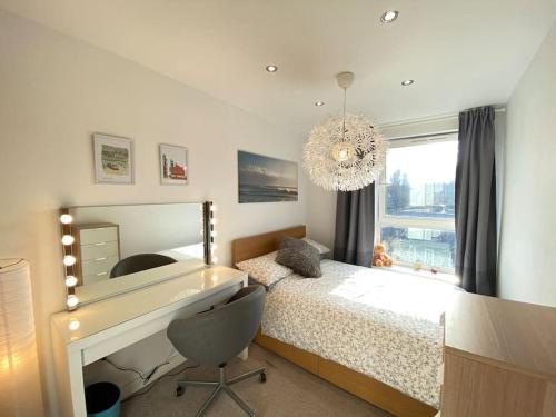 a bedroom with a desk and a bed and a window at Sheffield City Centre Apartment & Balcony in Sheffield