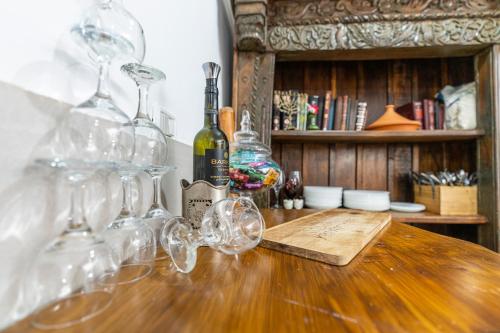 a bunch of wine glasses sitting on a wooden table at Ahuzat Shaul Seaside in H̱adera