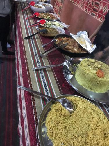 a row of plates of food on a table at Wadirum Zeid camp in Wadi Rum