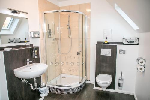 a bathroom with a shower and a sink and a toilet at Stadtperle Rostock in Rostock