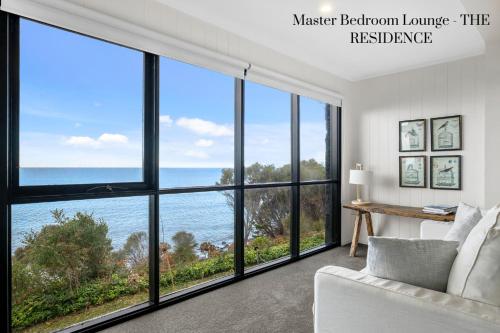 a living room with a view of the ocean at Hamptons on the Bay in Swansea