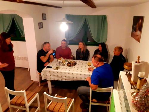 a group of people sitting around a table at Bakina iža in Duga Resa