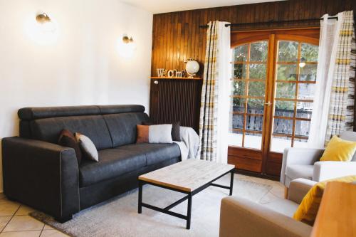 a living room with a couch and a table at Appartement Helios in Les Gets