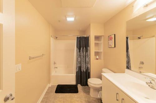 a bathroom with a shower and a toilet and a sink at Lovely 2BR/2BA!5MIN to Disney! Angelstadium! HondaCenter. in Anaheim