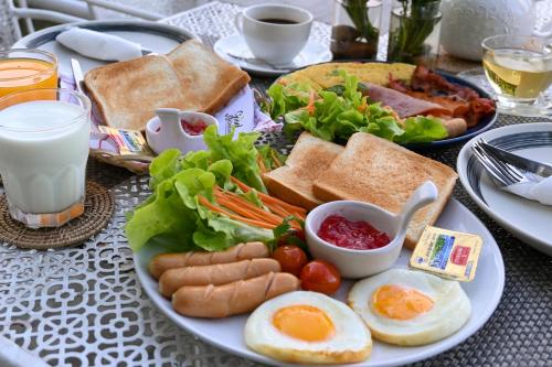 a plate of breakfast food with eggs bread and vegetables at Aranta Suvarnabhumi in Lat Krabang