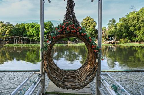 a basket filled with flowers on a body of water at Aranta Suvarnabhumi in Lat Krabang
