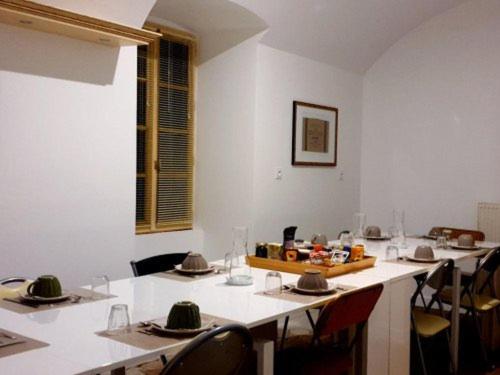 a dining room with tables and chairs with hats on them at La Picardière in Perdreauville