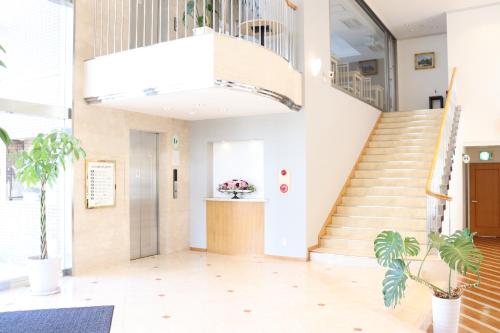 a staircase in a building with a lobby at Imabari Urban Hotel in Imabari
