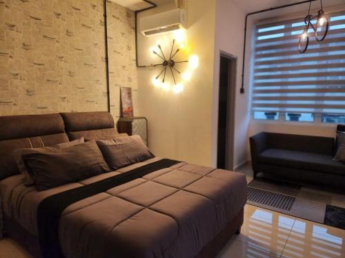 a bedroom with a bed and a clock on the wall at MP Villa with Cinema Room in Hock Lam Village