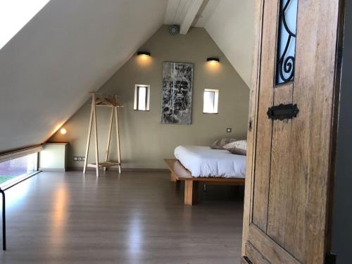a bedroom with a bed in a attic at Aux Portes de Durbuy in Clavier