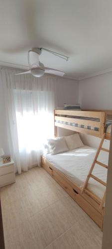 a bedroom with two bunk beds and a window at Villa Terreros in San Juan de los Terreros