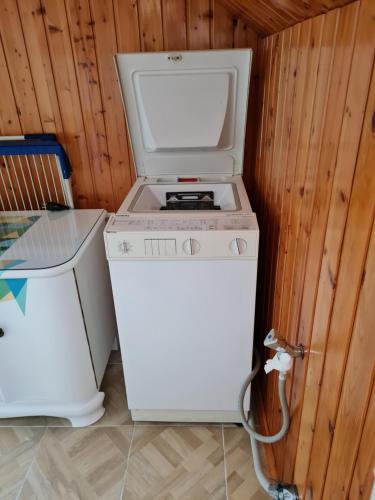 a washer and dryer sitting next to a wall at Ferienwohnung Erzgebirgsblick in Bernsbach