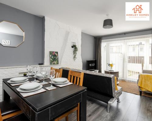 a dining room and living room with a table and chairs at Large & Spacious 3 Bedroom House with Parking & Wifi By Hinkley Homes Short Lets & Serviced Accommodation in Liverpool