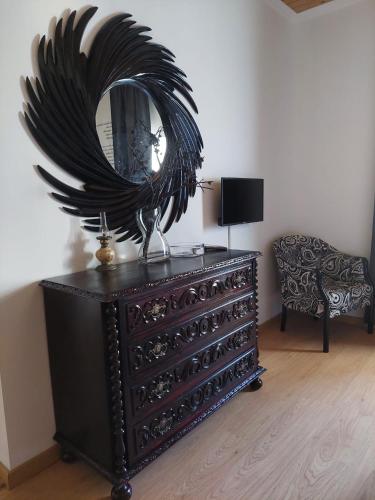 a dresser with a mirror on top of it at Sotam Country House EN342 in Góis