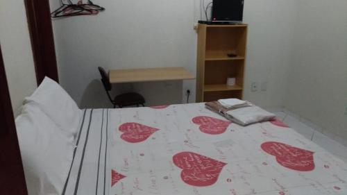 a bedroom with a bed with red hearts on it at Hotel Reimann in Indaiatuba