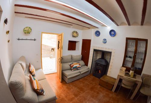 a living room with a couch and a fireplace at Casa Frasquita in Cehegín