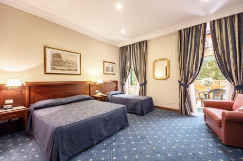 een hotelkamer met 2 bedden en een bank bij Hotel Artorius in Rome
