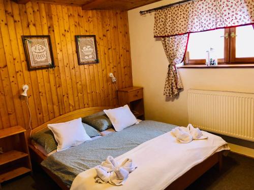 a bedroom with a bed with two towels on it at Privát Majo - Váš oddych na Liptove in Liptovský Mikuláš