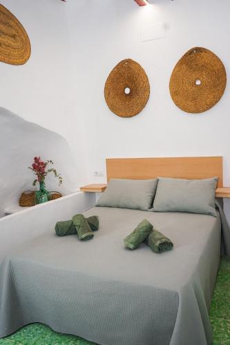 a bedroom with a bed with two stuffed animals on it at Casa Frasquita in Cehegín