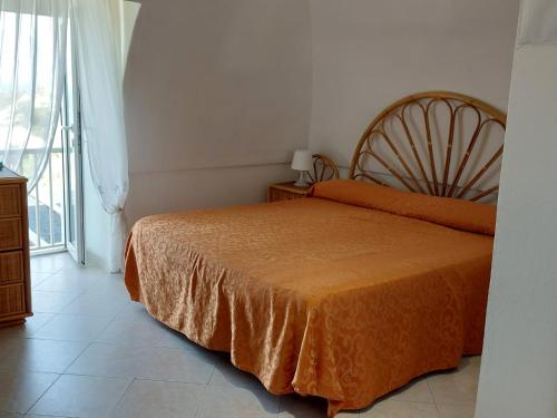 ein Schlafzimmer mit einem Bett und einem großen Fenster in der Unterkunft Casadelpino Residence La Piana in Ponza
