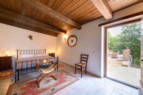 a bedroom with a bed and a large window at Agriturismo Casanova in Gubbio