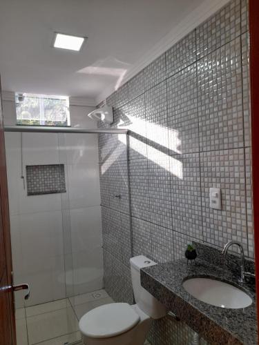 a bathroom with a toilet and a shower and a sink at pousada Montanhez ap5 in Alto Caparao