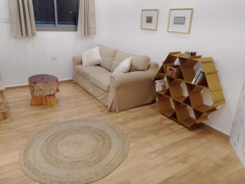 a living room with a couch and a table at Beautiful beach apartment in Ashdod