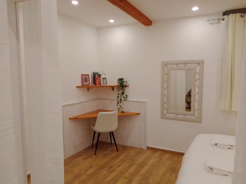 a room with a table and a chair and a mirror at Beautiful beach apartment in Ashdod