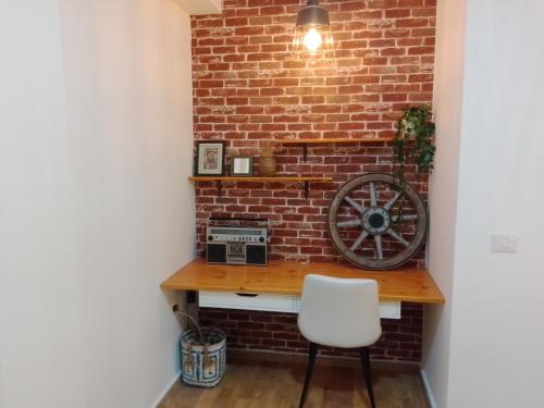 a brick wall with a desk and a chair at Beautiful beach apartment in Ashdod