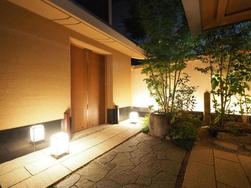 a building with lights on the side of it at Sora Niwa Terrace Kyoto Bettei in Kyoto