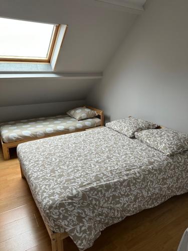 a bedroom with a bed and a window at Magnolia58 in Pontault-Combault
