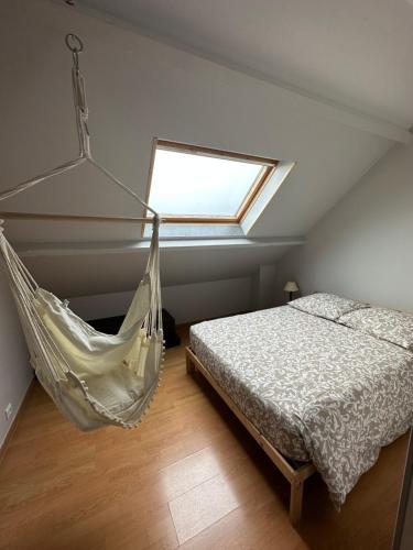 a bedroom with a hammock bed and a window at Magnolia58 in Pontault-Combault