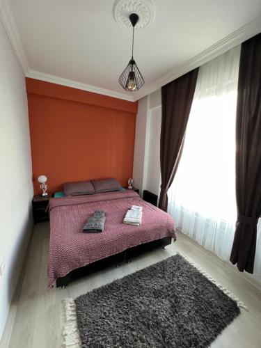 a bedroom with a bed with a pink blanket and a rug at Chic& cosy house with Kars Panorama in Kars