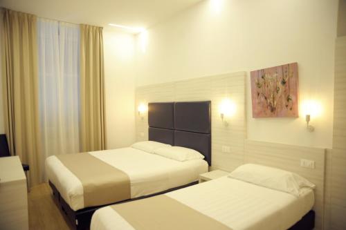 Postel nebo postele na pokoji v ubytování Hotel Fioralba