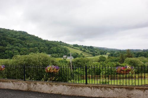 a wrought iron fence with flowers on it at Glendun Self Catering in Cushendall