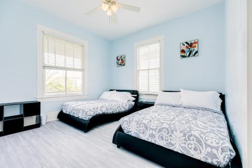 a bedroom with two beds and a ceiling fan at Ocean Waves in Galveston