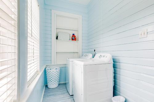 a bathroom with a sink and a washing machine at Ocean Waves in Galveston