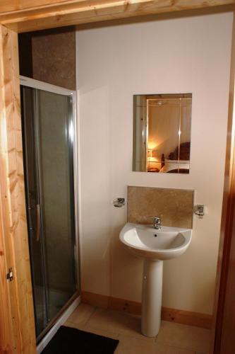 a bathroom with a sink and a shower at Glendun Self Catering in Cushendall