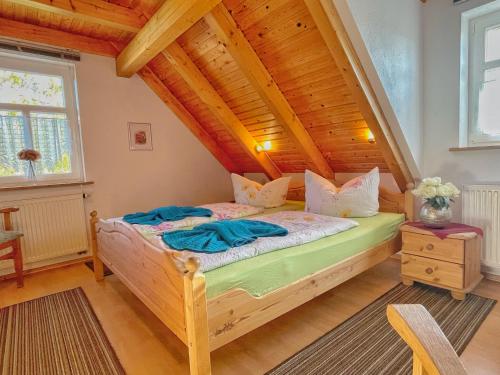 a bedroom with a bed with a wooden ceiling at Altes Forsthaus im Harz in Elbingerode