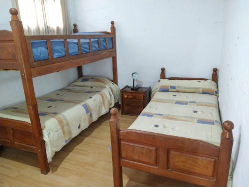 a bedroom with two bunk beds and a table at Casona Alma en Calma San Rafael in San Rafael