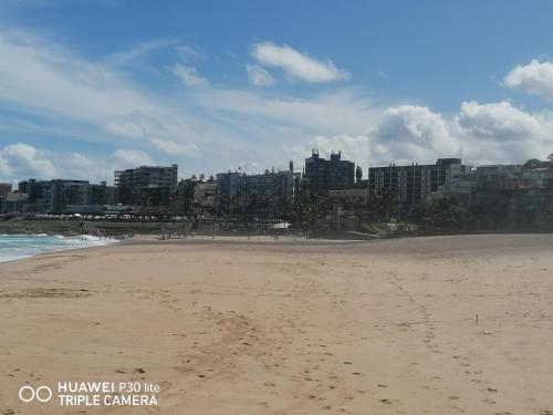 a sandy beach with buildings in the background at Kingsview 201 in Margate