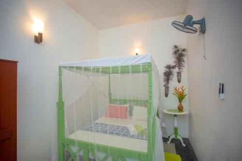 a room with a bed with a canopy at Percy Residence in Unawatuna