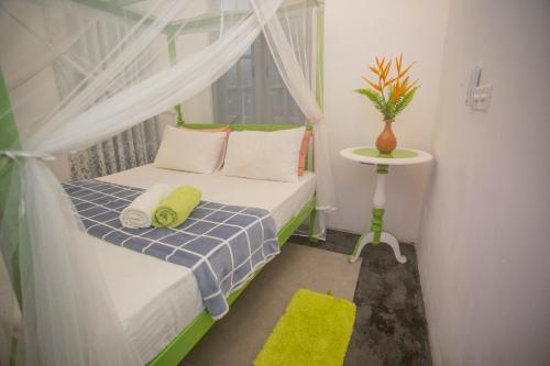 a small bedroom with a bed and a window at Percy Residence in Unawatuna