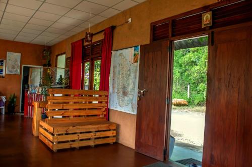 a wooden bench in a room with a window at Water Side Residence in Adams Peak