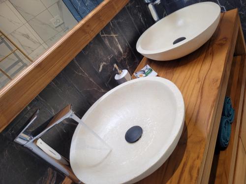 a bathroom with a white sink and a toilet at Le Refuge d'Heva in Salazie