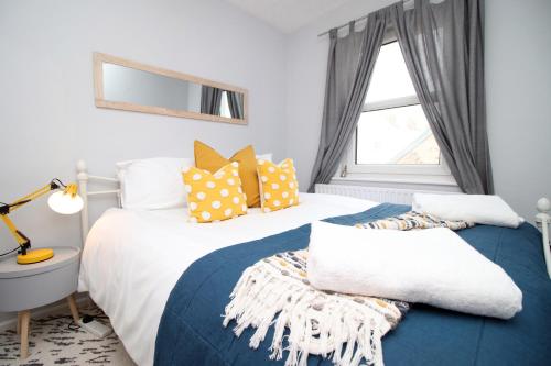 a bedroom with two beds and a window at K Suites - Selkirk Street in Cheltenham